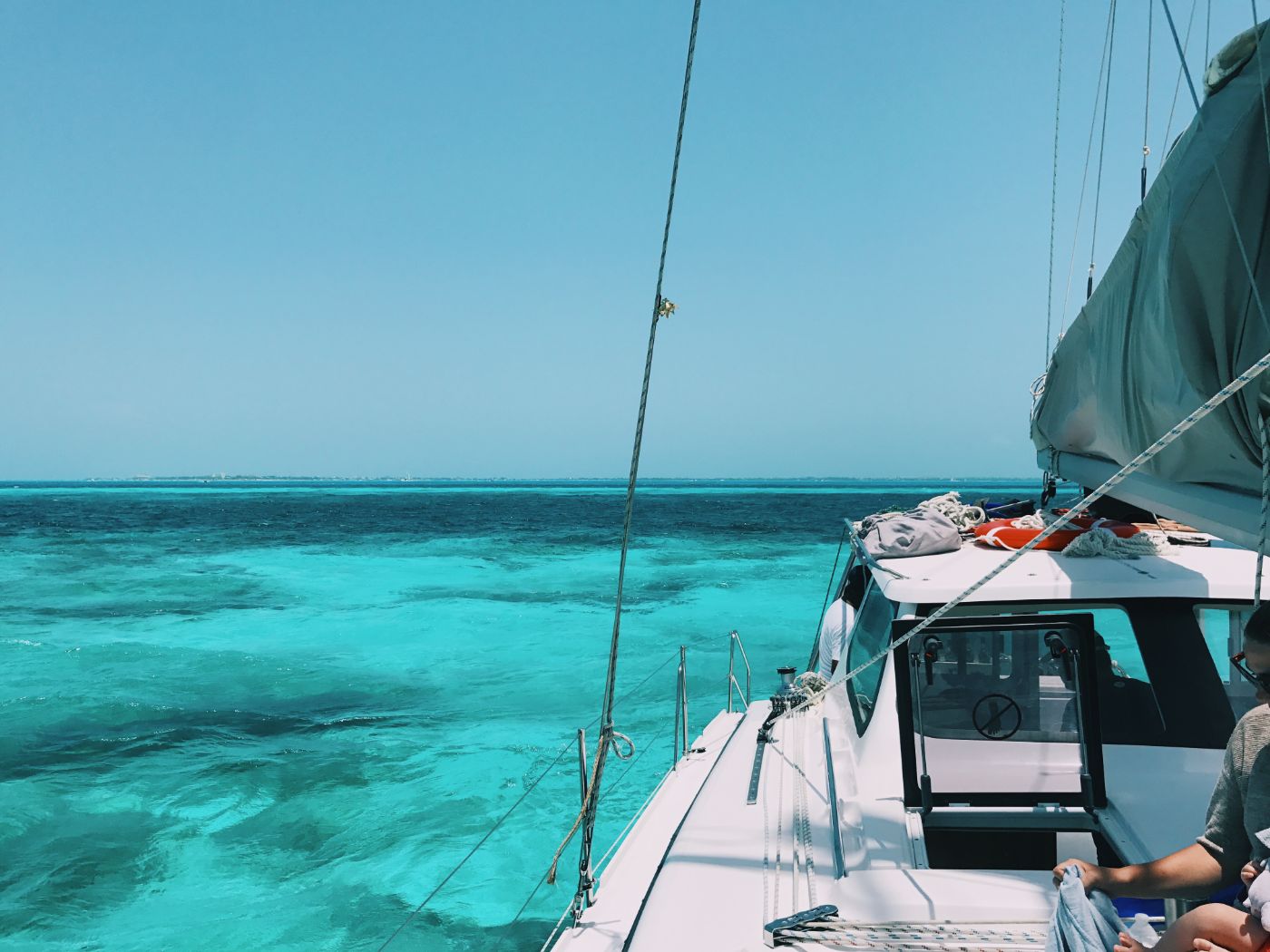 off the bow of a sailboat