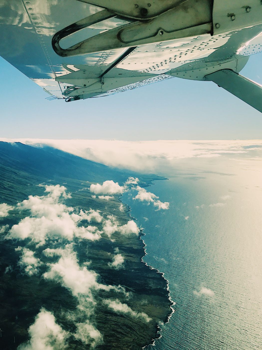 a wing over clouds